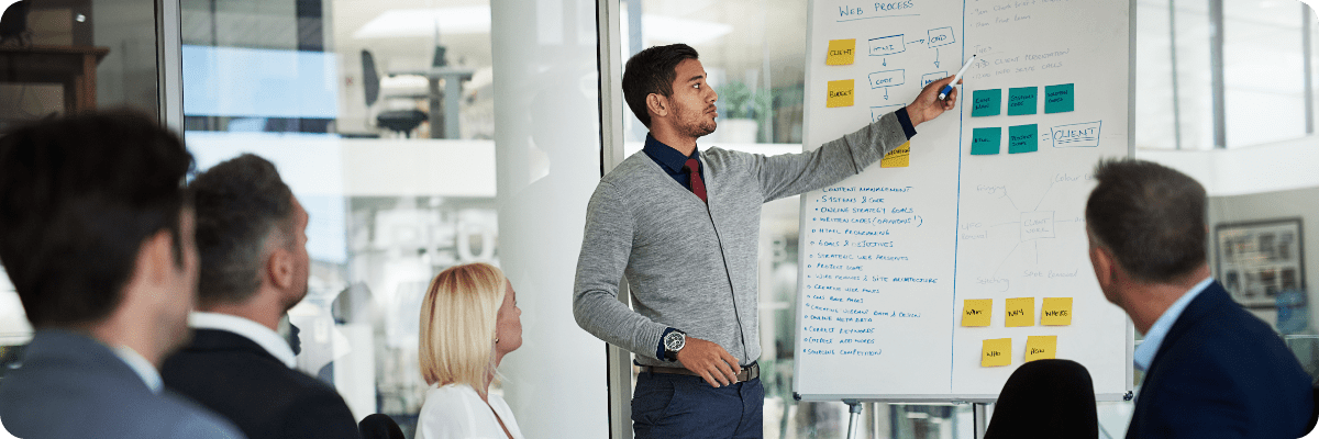 Young male entrepreneur presenting his small business plan to a board of financial investors