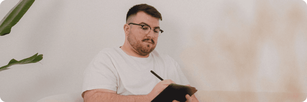 Ross Powell, co-founder of The Business Tea, making strategic marketing notes on a tablet in preparation for a marketing consultancy session with a client.