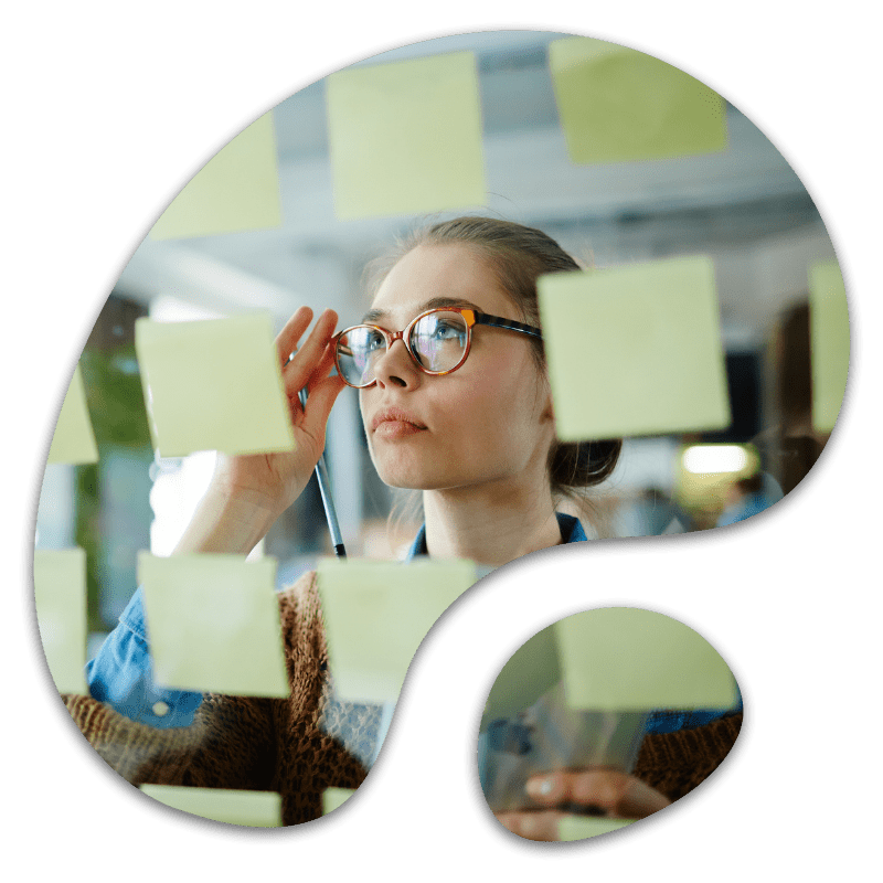 Young female planning business ideas using sticky notes, representing early-stage marketing strategy and pre-launch business planning