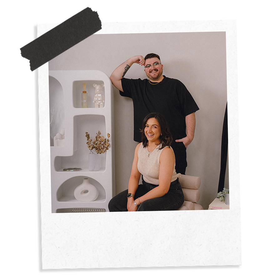 The Business Tea's Approach To SEO Packages: Sarah and Ross photographed leaning against a bookshelf.