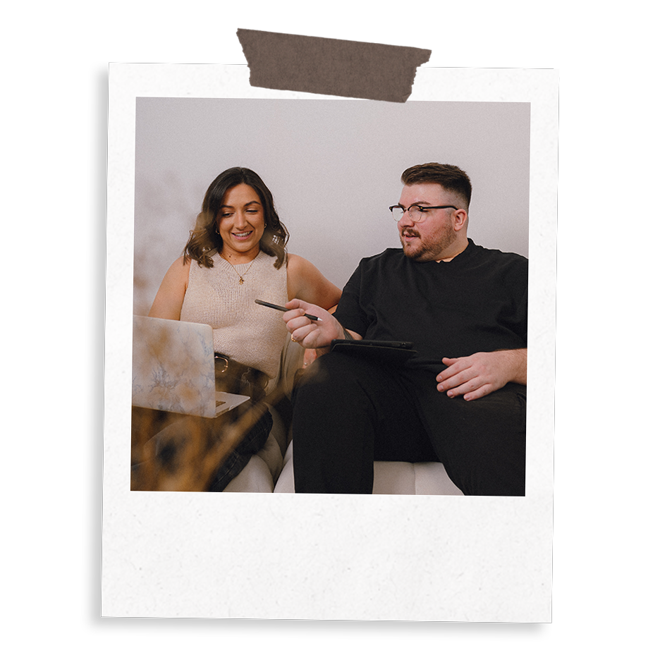 The Business Tea's Sarah and Ross Powell working on a social media content strategy for a client, conversing over a laptop.