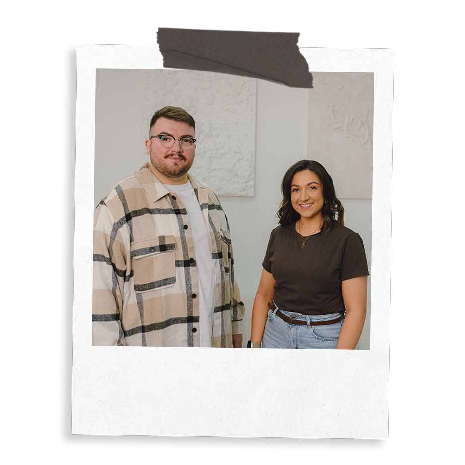 The Business Tea's Sarah and Ross Powell stood in a studio environment.