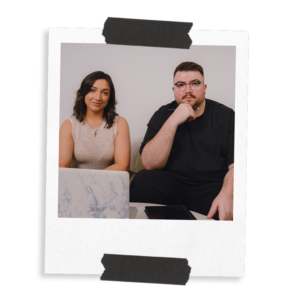 The Business Tea's Sarah and Ross Powell looking serious, straight to camera, with a laptop and iPad on a table.