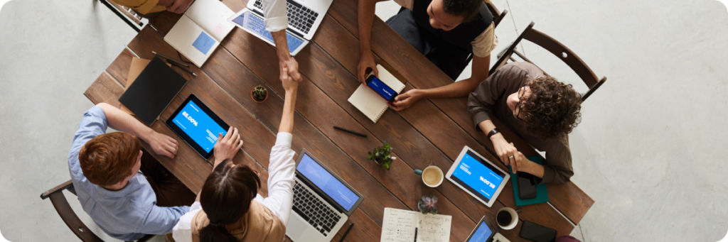 A group of stakeholders reviewing a marketing roadmap and marketing strategy around a large table.