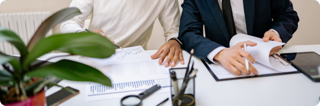 A digital marketer working with a finance executive to understand commercials in preparation for creating a marketing strategy and marketing roadmap.